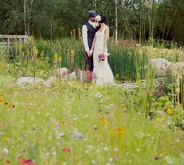 Outdoor wedding at WWT London Wetland Centre with lush greenery and vibrant flowers.